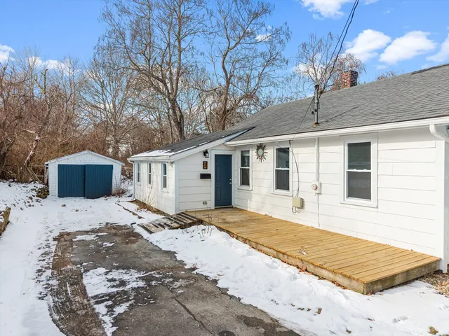 a view of a house with snow on the road