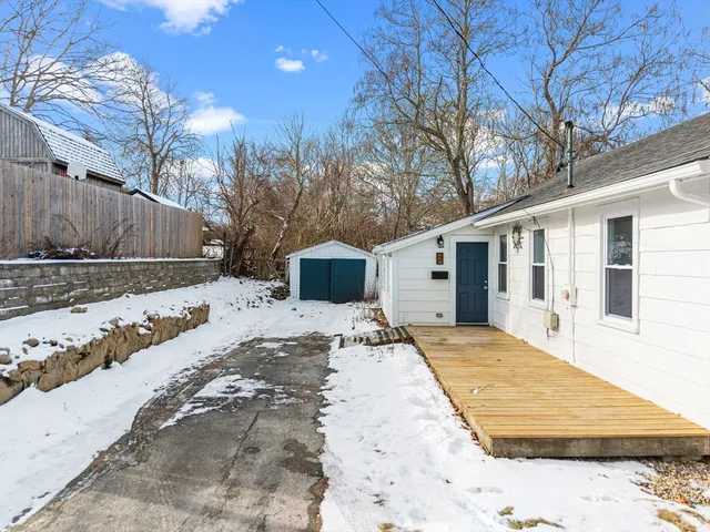 a view of a house with snow on the road
