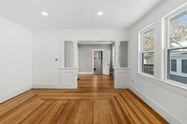 a view of a room with wooden floor and brick walls