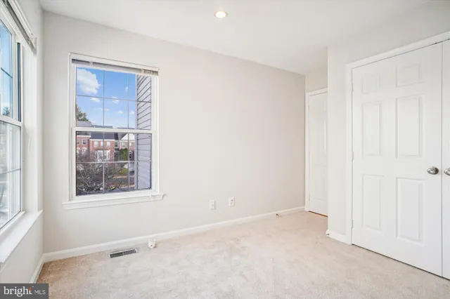 an empty room with windows and stairs