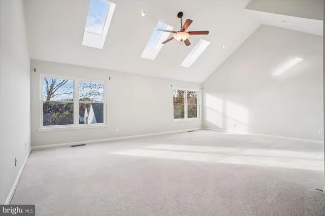 a spacious bedroom with a bed and a chandelier