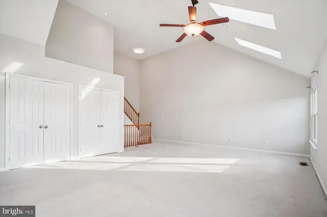 a view of staircase with railing and white walls
