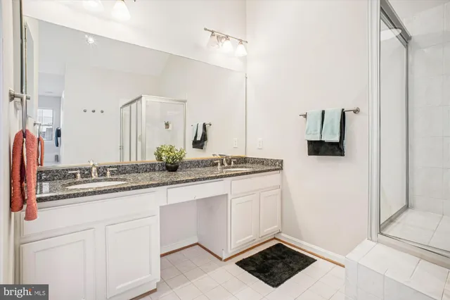 a large bathroom with a shower a sink and a mirror
