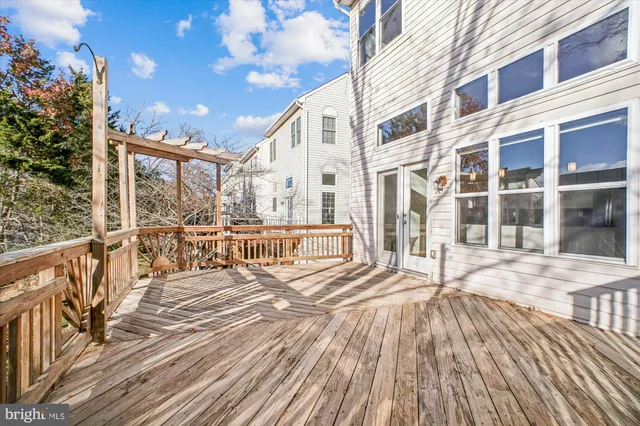a front view of a house with a garden and trees
