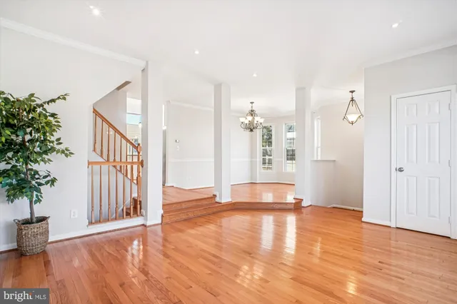 a open kitchen with granite countertop a stove top oven a sink dishwasher a dining table and chairs with wooden floor