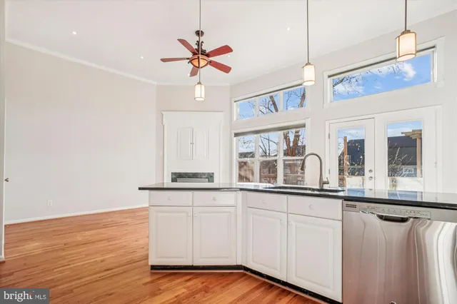 a kitchen with stainless steel appliances granite countertop a refrigerator a stove a sink and a microwave