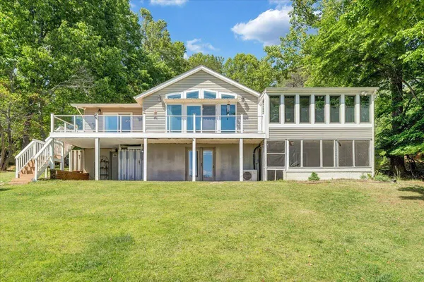 a big house with a big yard and large trees