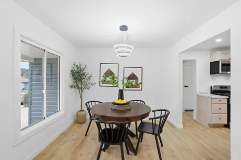 a view of a dining room with furniture and chandelier