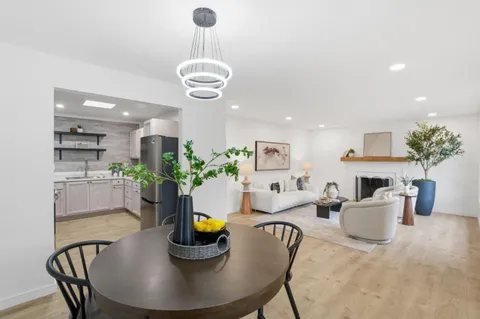 a view of a dining room with a table and chairs