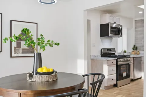 a view of a dining room with furniture and chandelier