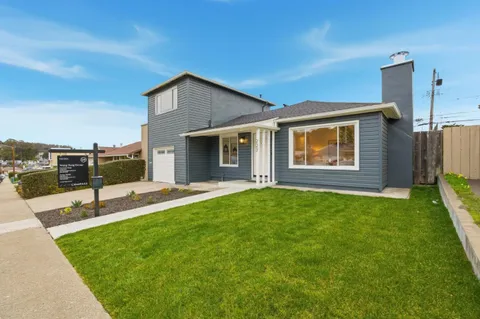 a view of a backyard with a garden and plants