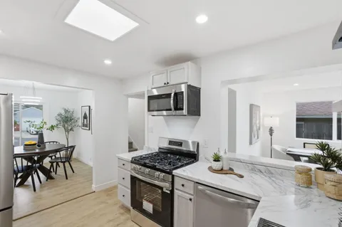 a kitchen with stainless steel appliances a sink and cabinets