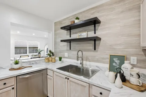 a kitchen with a potted plant on the counter and cabinets