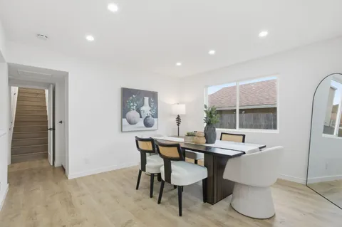 a bedroom with a bed and a painting on the wall