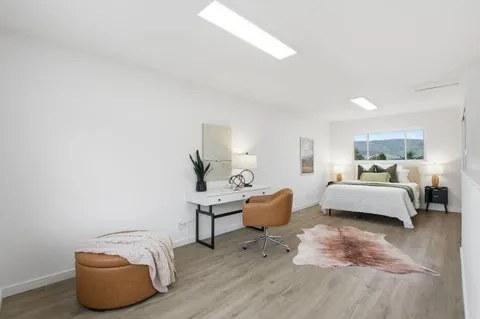 a view of a house with swimming pool and sitting area