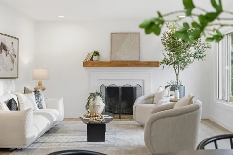 a living room with furniture and a fireplace
