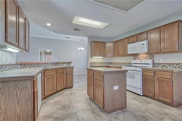 a kitchen with granite countertop cabinets stainless steel appliances and a counter space