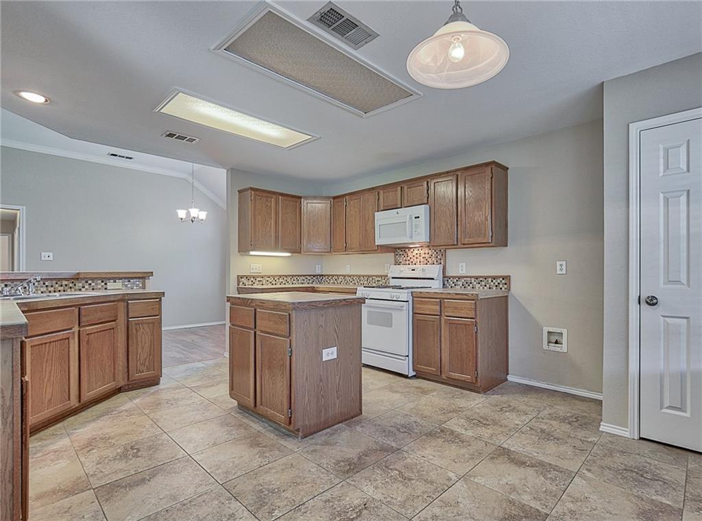 404 Faircloud Lane McKinney, TX 75072 - Photo 12 of 26 a kitchen with a stove top oven sink and cabinets