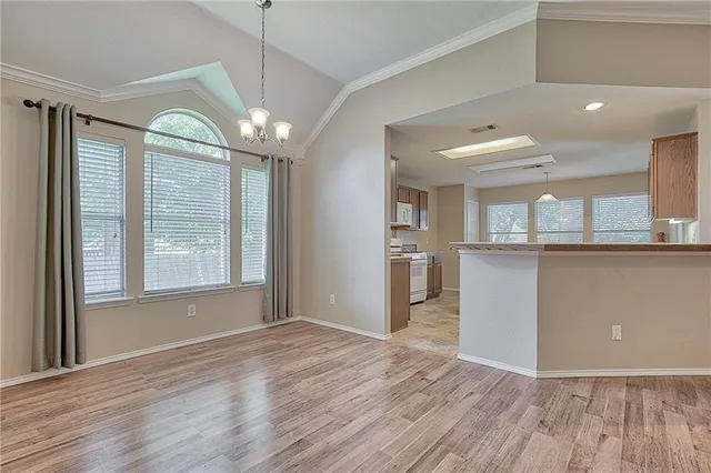 a view of a kitchen with a dishwasher cabinets and a large window