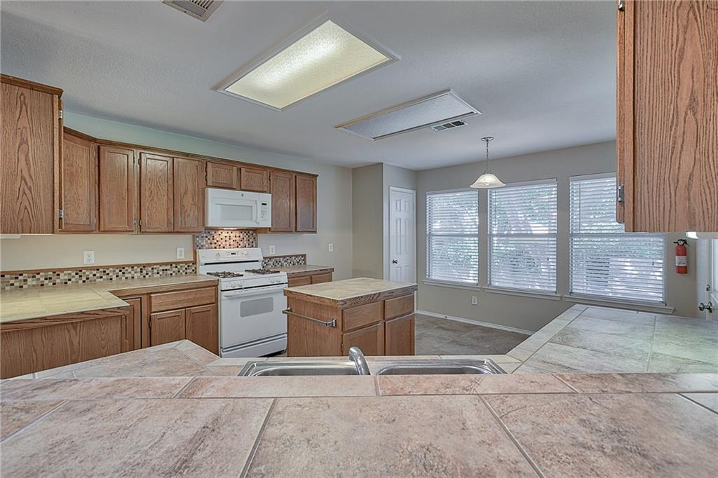 404 Faircloud Lane McKinney, TX 75072 - Photo 8 of 26 a kitchen with a stove a sink and cabinets