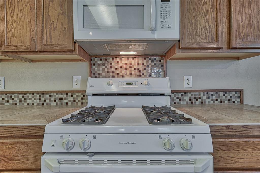 404 Faircloud Lane McKinney, TX 75072 - Photo 10 of 26 a kitchen with stove and cabinets