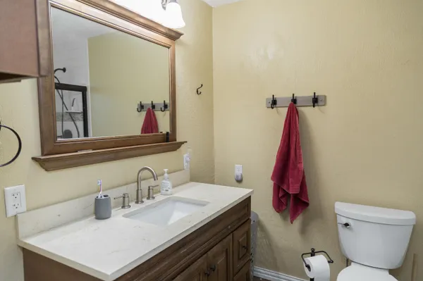 a bathroom with a sink vanity and mirror