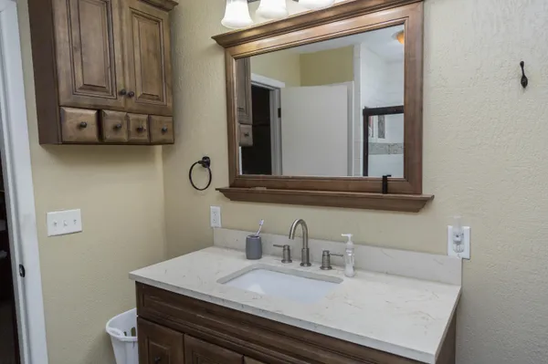 a bathroom with a sink and a mirror