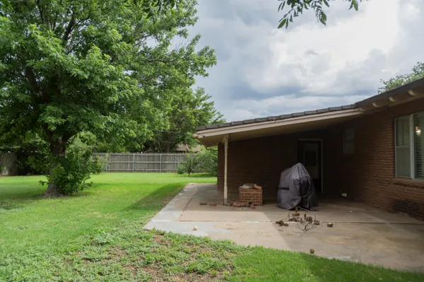 a front view of a house with a garden and yard