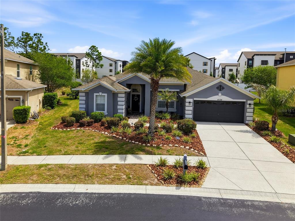 4154 Braemere Drive Spring Hill, FL 34609 - Photo 1 of 95 a front view of a house with garden