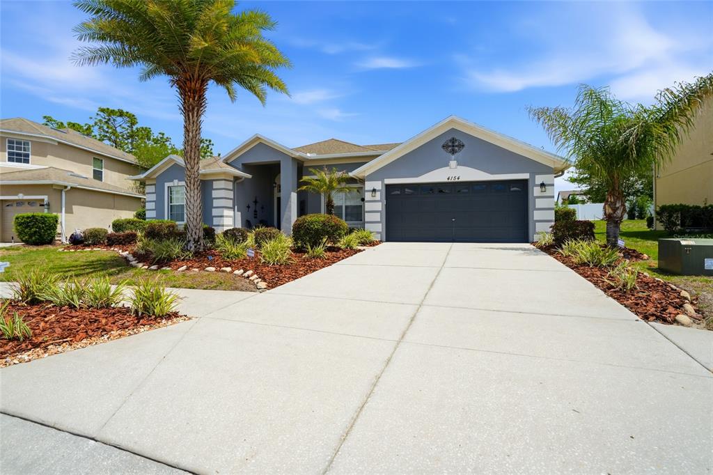 4154 Braemere Drive Spring Hill, FL 34609 - Photo 2 of 95 a front view of a house with a yard and garage