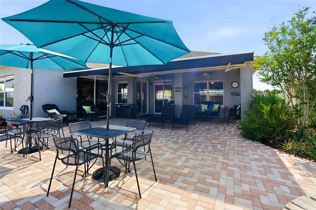 4154 Braemere Drive Spring Hill, FL 34609 - Photo 30 of 95 a view of a patio with a table and chairs under an umbrella