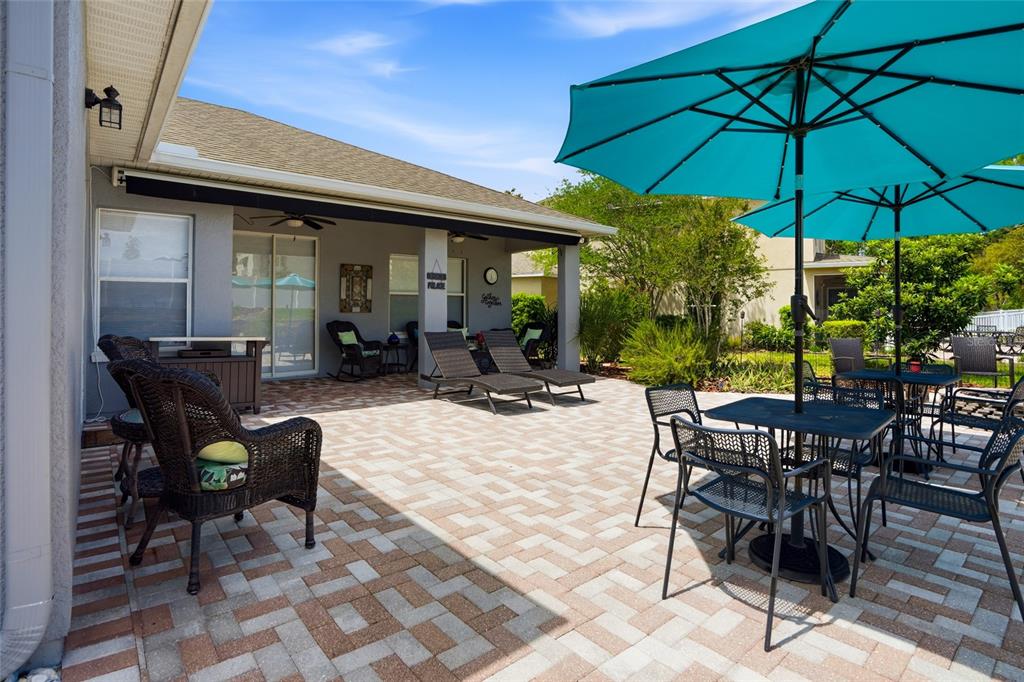 4154 Braemere Drive Spring Hill, FL 34609 - Photo 39 of 95 a view of a patio with table and chairs under an umbrella