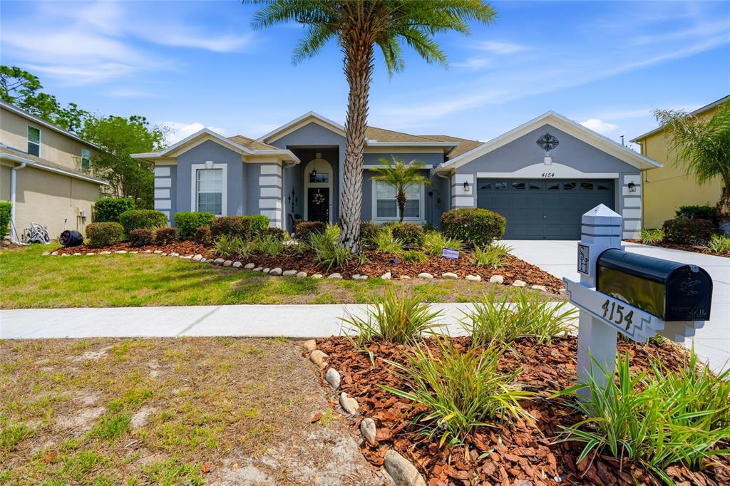 4154 Braemere Drive Spring Hill, FL 34609 - Photo 4 of 95 a front view of a house with a yard and garage