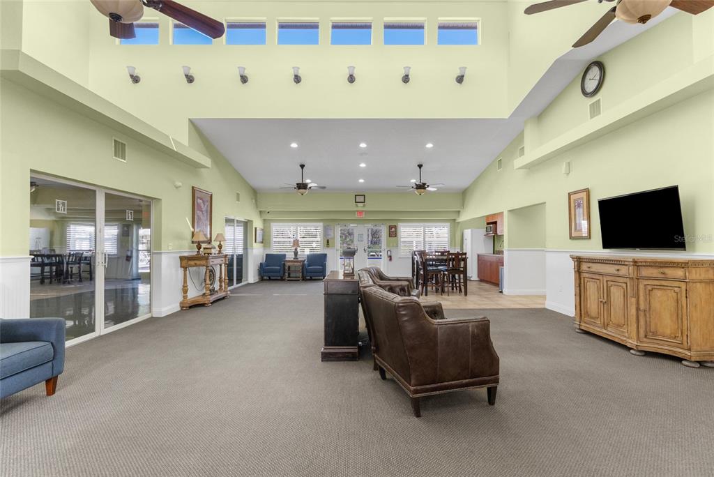 4154 Braemere Drive Spring Hill, FL 34609 - Photo 72 of 95 a living room with furniture and a flat screen tv