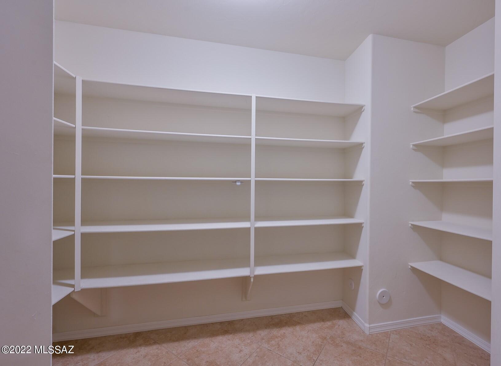 10804 East Salsabila Road Tucson, AZ 85747 - Photo 20 of 50 a view of walk in closet with empty racks