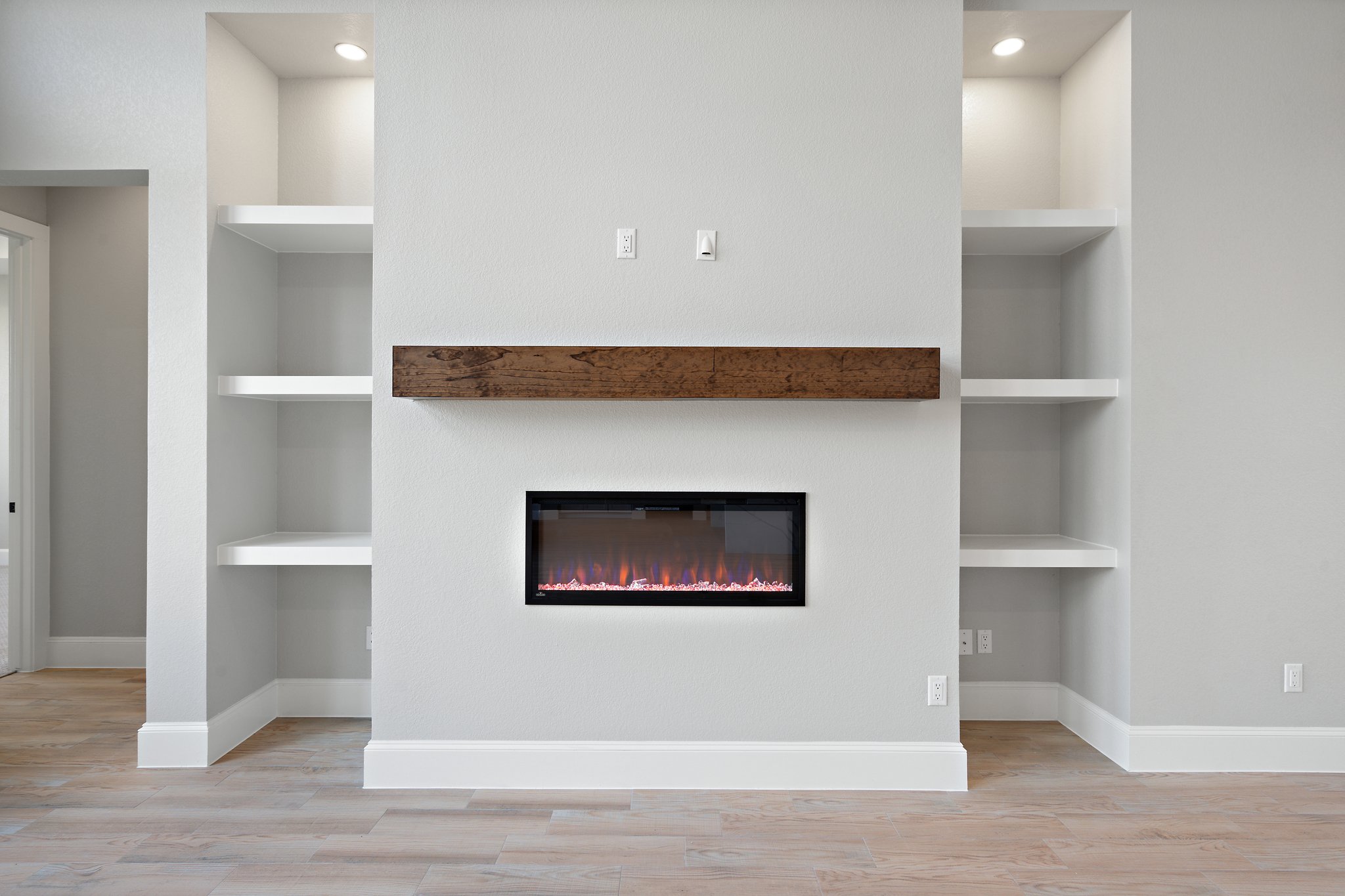 308 Axis Loop Georgetown, TX 78628 - Photo 13 of 40 a hallway with a wooden floor and a fireplace