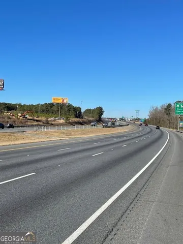 a view of street with a car parked on road
