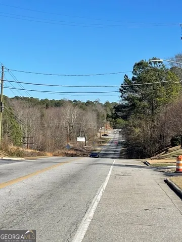 a view of a street with a cars parked on the road