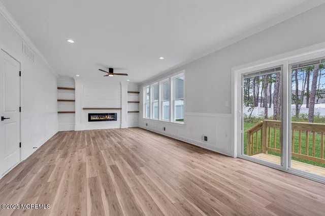 a view of empty room with cabinet and wooden floor