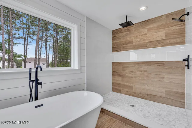 a bathroom with a tub and shower