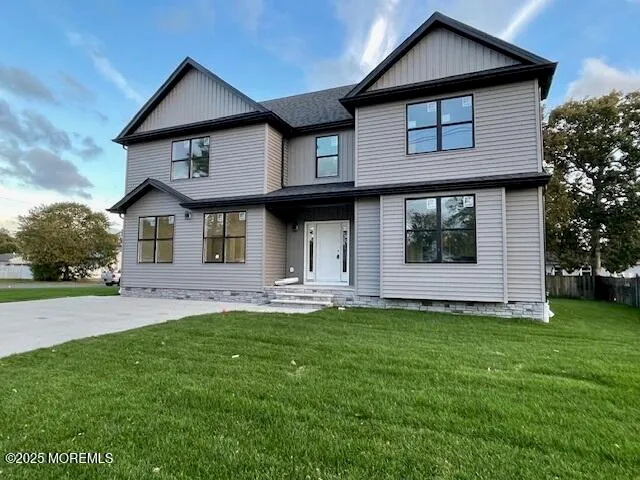 a front view of a house with a garden and yard