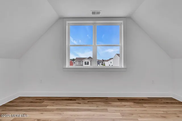 a view of water heater room with wooden floor