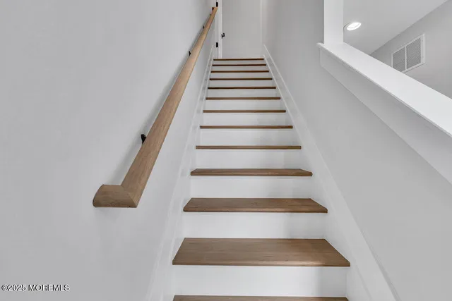 a view of an empty room and wooden floor