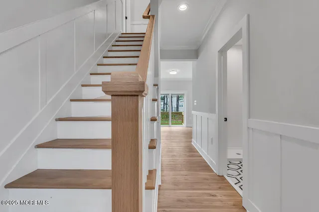 a view of a hallway with wooden floor and entryway