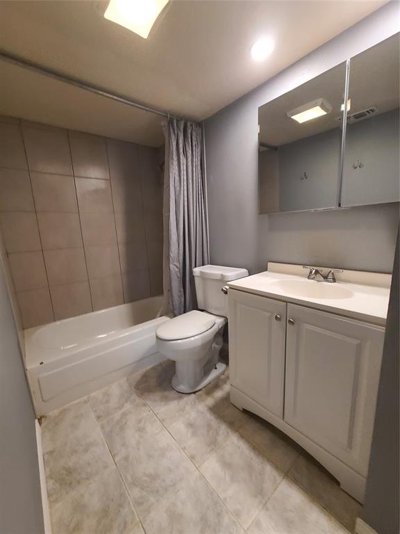 5644 Perrin Street The Colony, TX 75056 - Photo 12 of 16 Full bathroom featuring vanity, tile patterned flooring, toilet, and shower / bath combination with curtain