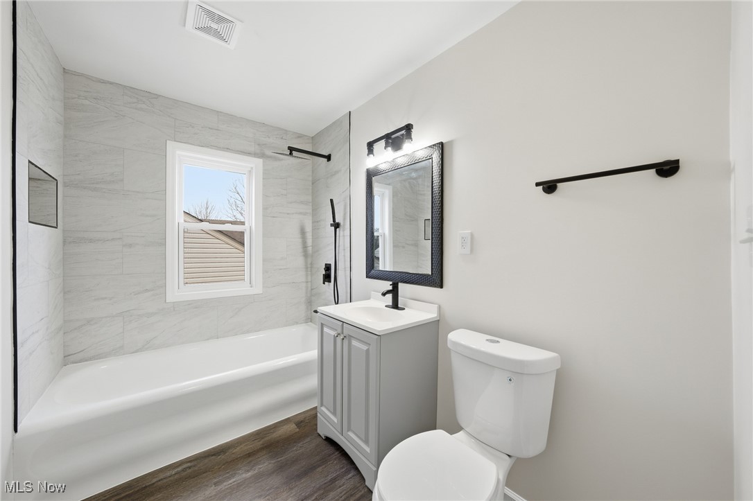 7911 Snow Road Parma, OH 44129 - Photo 26 of 44 Full bathroom with shower combination, vanity, and dark wood-style floors