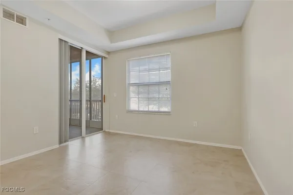 an empty room with windows and closet