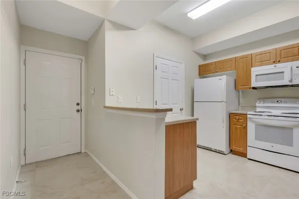 a kitchen with stainless steel appliances a refrigerator and a stove top oven