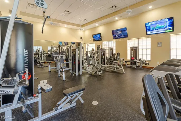 a gym room with lots of gym equipment