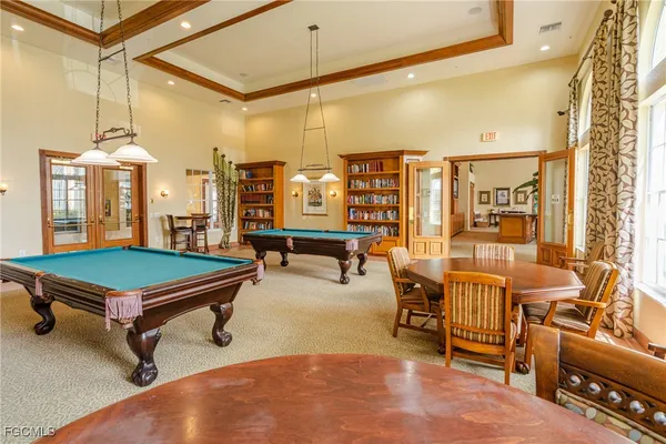 a living room with furniture a table and chairs